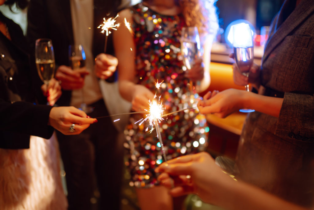 Sparkling,Sparklers,In,The,Hand.,Group,Of,Happy,People,Holding